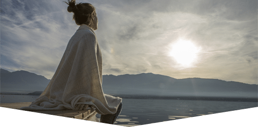 Woman looking out over a lake